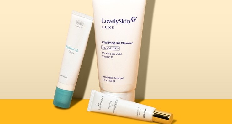 Tubes of LovelySkin LUXE Clarifying Gel Cleanser and retinol creams from OBAGI and SkinMedica pictured on a light yellow background.
