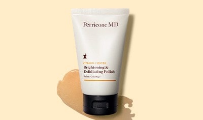 A cream bottle of Perricone MD Vitamin C Ester Brightening & Exfoliating Polish with an orange swatch of exfoliating polish behind it.