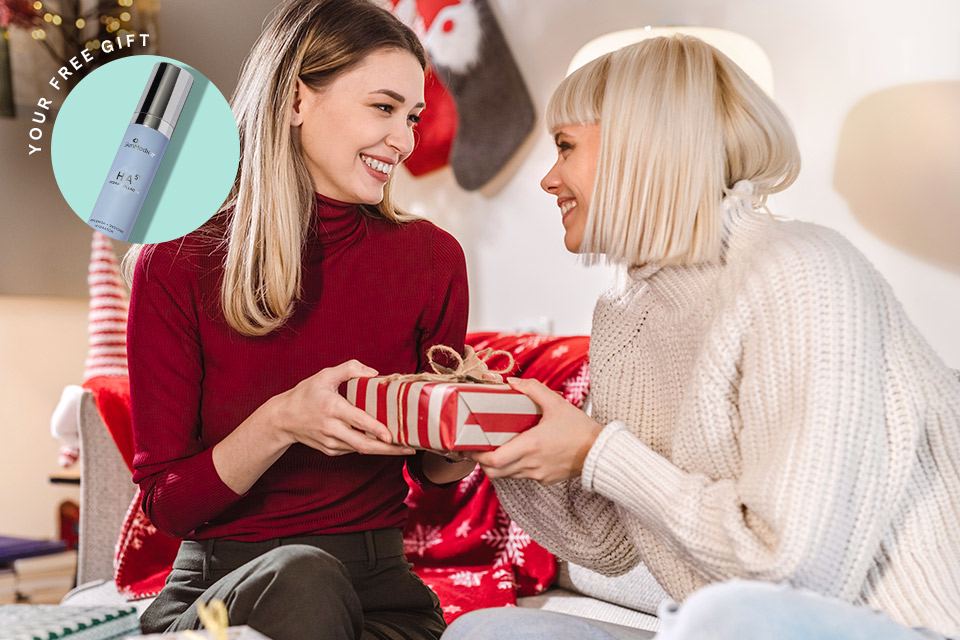 Two friends exchanging a holiday present