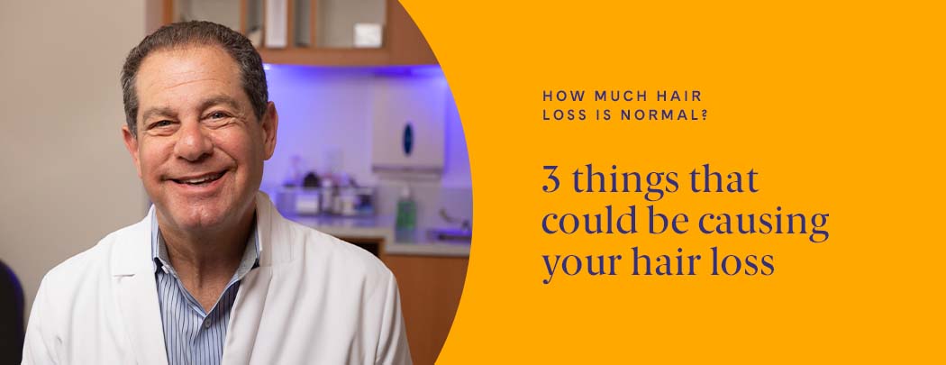 A doctor with light to medium-toned skin and light brown hair wearing a blue shirt and a white doctor's jacket smiles at the camera.