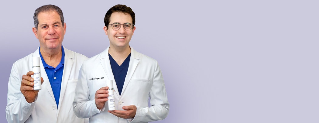 Drs. Joel and Daniel Schlessinger stand next to one another smiling while holding LovelySkin LUXE Firming Peptide Neck Cream.