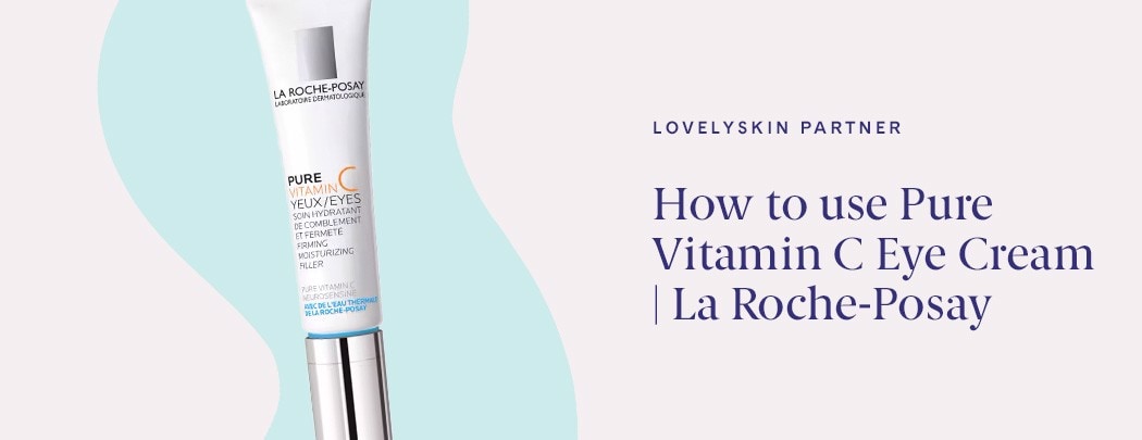 A white tube of La Roche-Posay Pure Vitamin C Eye Cream with a silver lid on a blue and gray background.