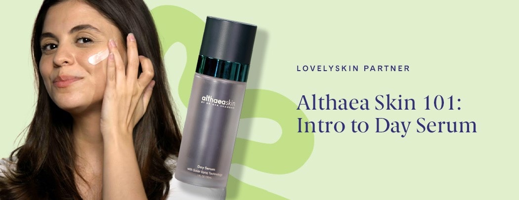 A woman with medium, olive-toned skin and medium brown hair applies Althaea Skin Day Serum to her cheek.