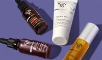 Four products, one in a white tube, two in clear glass bottles, and one in a brown glass bottle, lay on a medium purple background.
