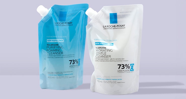 Two refill pouches of La Roche-Posay cleansers standing up on a lavender background.