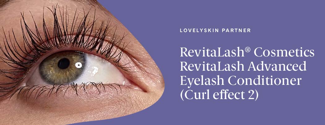 A person with olive-toned skin gazes upward. Their eye is a greenish hazel. Their eyelashes are long, lush and full.