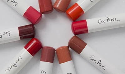 Ten Ere Perez Coco Crayons are laid in a circle with their colored ends touching one another.