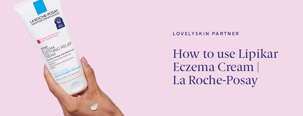 A woman's hand holds a bottle of La Roche-Posay Lipikar Eczema Cream