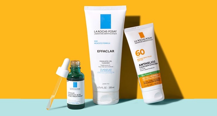 La Roche-Posay Effaclar cleanser and salicylic acid serum with eyedropper on an orange background