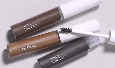 Three tubes of Ere Perez Argan Brow Hero lay next to one another. One has its lid off. All shades are shown.