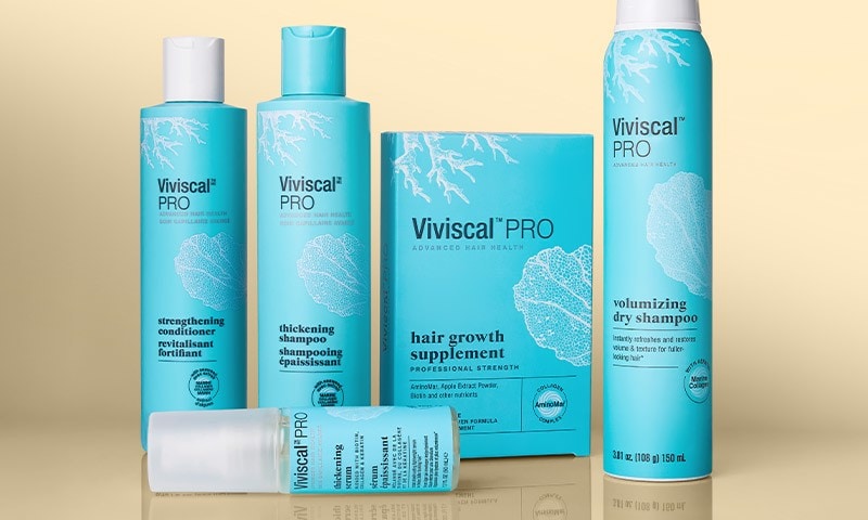 Viviscal PRO products standing on a reflective mirror surface