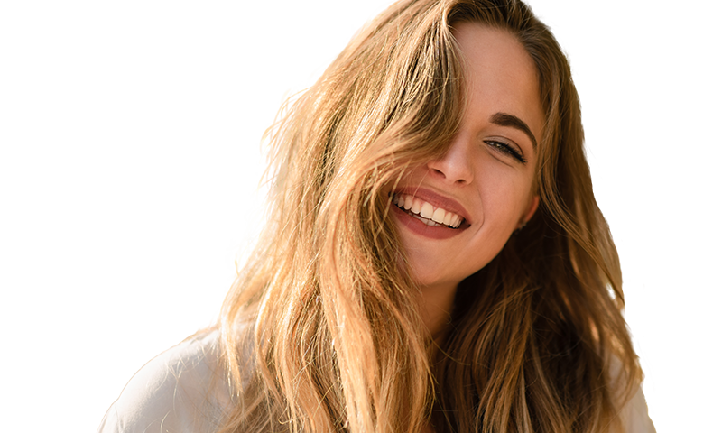 Smiling young woman with hair covering one of her eyes