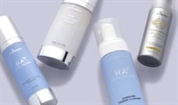 SkinMedica HA5 Cleanser and Hydrator lay next to SkinMedica TNS Advanced+ Serum and Essential Defense SPF.