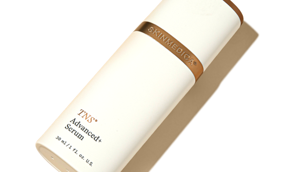 A bottle of SkinMedica TNS Advanced+ Serum laying flat