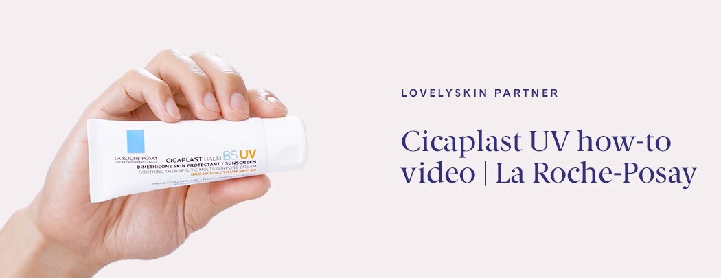 A male hand with medium skin tone holding a bottle of La Roche-Posay Cicaplast Baume B5 Soothing Multi-Purpose Cream SPF 50