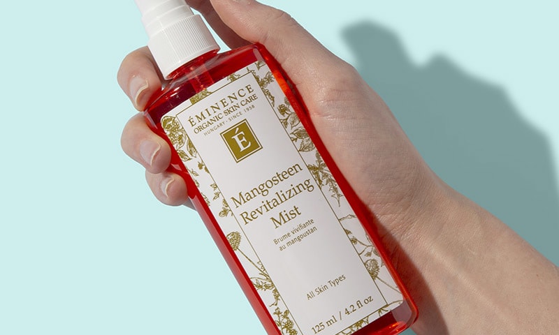 Hand holding Mangosteen Revitalizing Mist