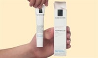 Two hands holding La Roche-Posay Pigmentclar Eye Cream tube and box