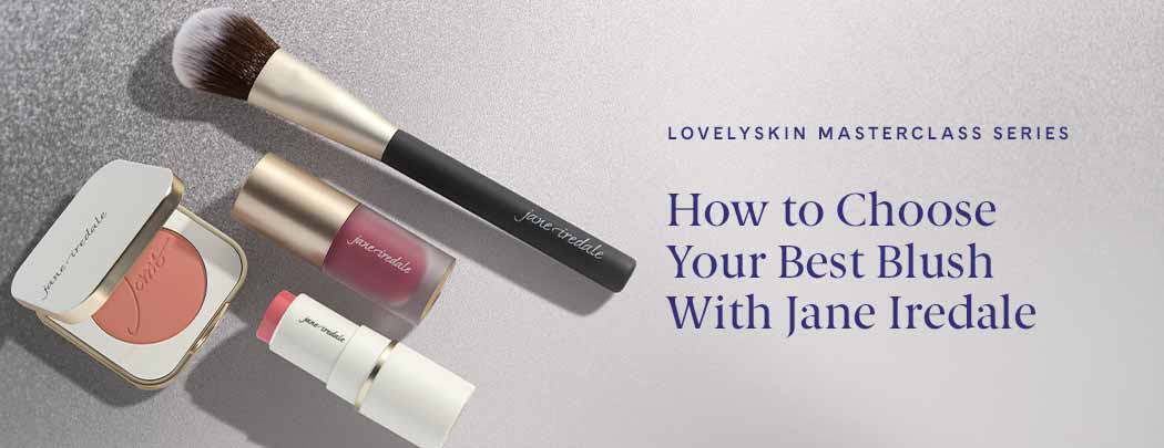 A powder blush in a compact, a cream blush in a tube, and a liquid blush in a tube lay next to a blush brush.