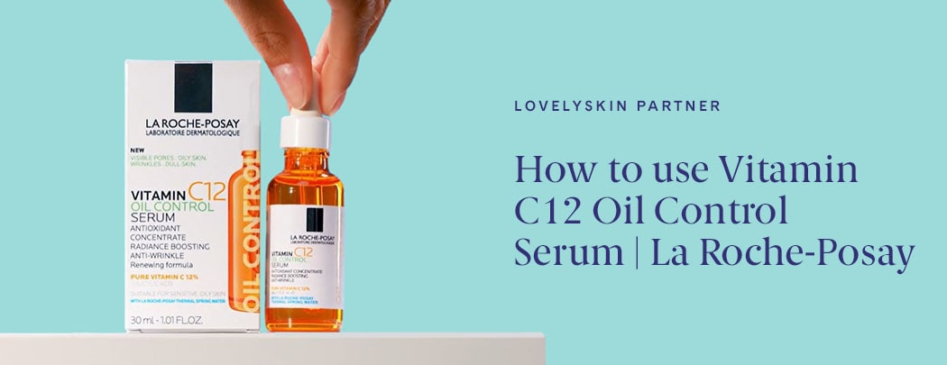 Fingers holding onto a bottle of La Roche-Posay Vitamin C12 Oil Control Serum, which is next to its packaging