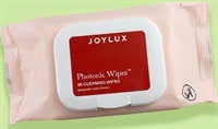 A package of Joylux Photonic Wipes™ Device Cleaning Wipes sits atop a digital illustration. The illustration is green and squiggly.