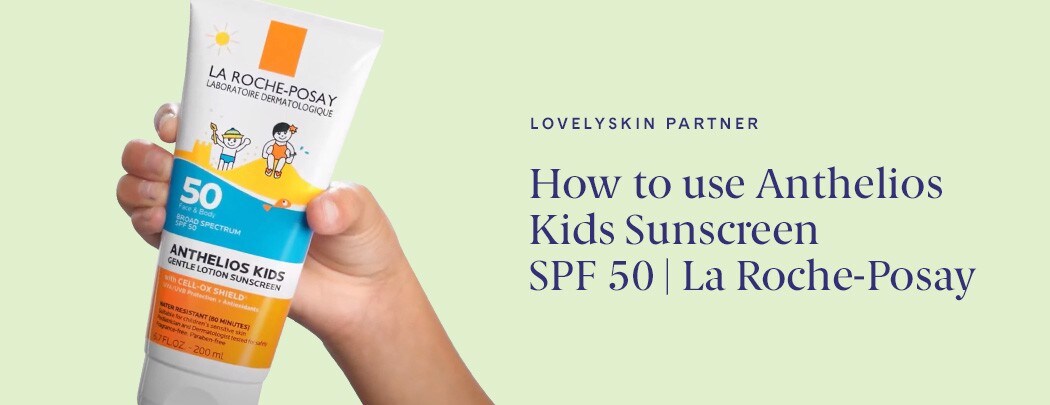 A hand with a medium skin tone holds a bottle of La Roche-Posay Anthelios Kids Gentle Lotion Sunscreen SPF 50