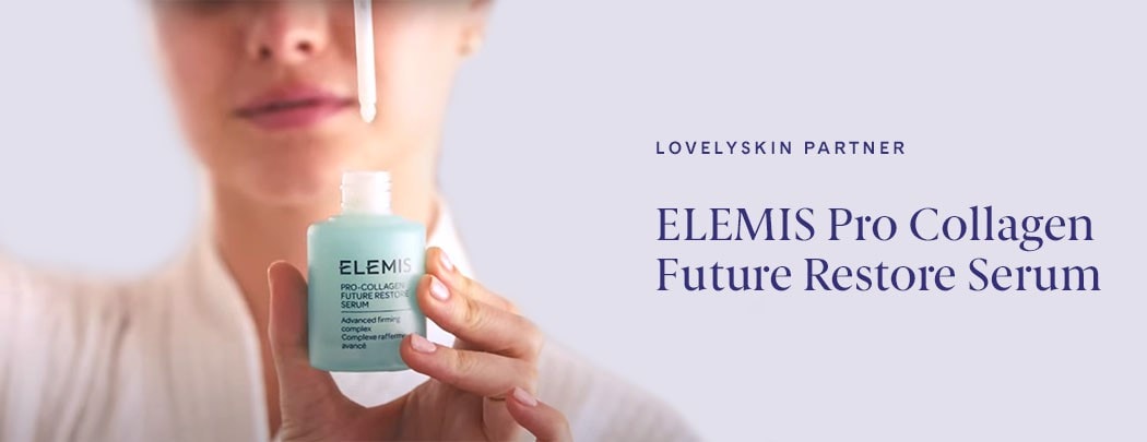 A white woman holding a bottle of ELEMIS Pro Collagen Future Restore Serum with a dropper suspended above it.