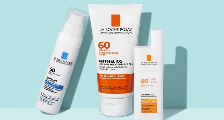 Three La Roche-Posay Anthelios sunscreen bottles on a light blue background.