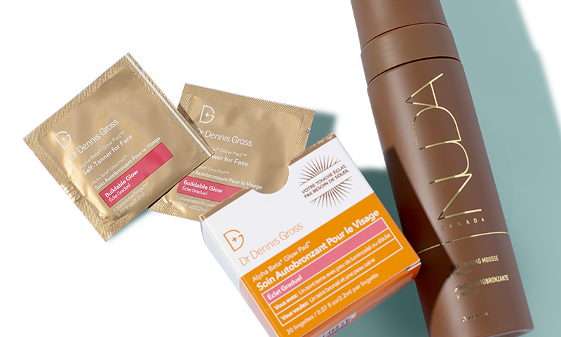 Dr. Dennis Gross Alpha Beta Glow Pad Self-Tanner for Face pads and packaging alongside a NUDA Self-Tanning Mousse bottle against a light background.