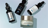 Three SkinCeuticals serums are artfully arranged over a jar of SkinCeuticals Triple Lipid Restore 2:4:2