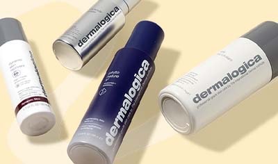 A smattering of Dermalogica products lay over a yellow background.