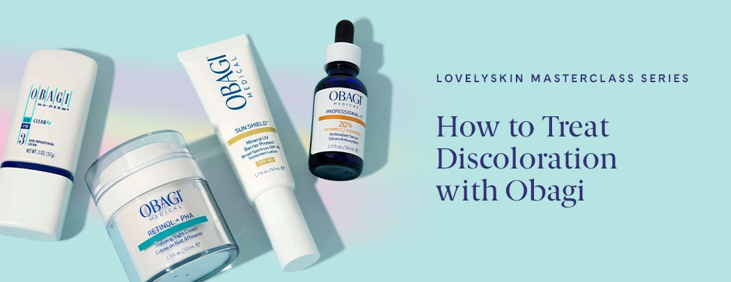 Four products lay over a blue background with a rainbow hue. There is a treatment, a cream, a sunscreen and a serum.