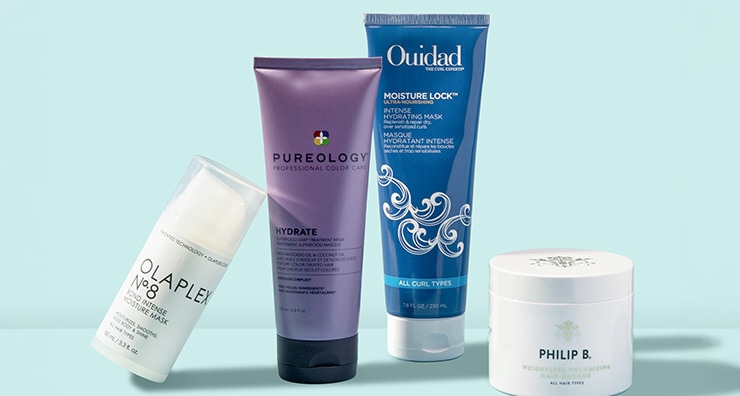 Hair masks by OLAPLEX, Pureology, Ouidad and Philip B. pictured on a light blue background.
