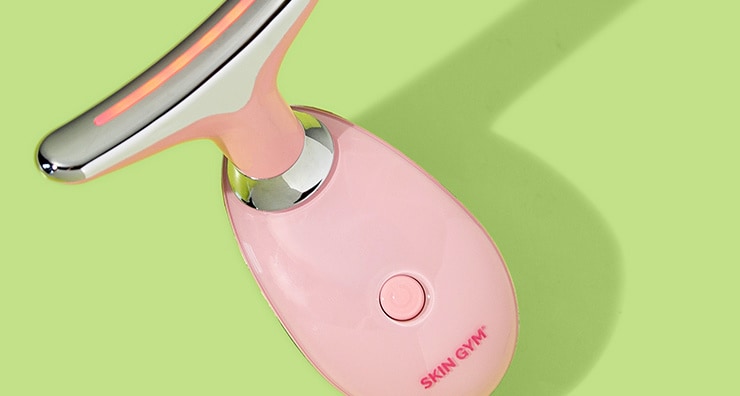 The light pink Skin Gym LitLift LED Facial Tool on a light green background.