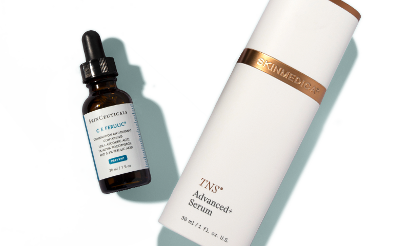 C E Ferulic and TNS Advanced+ Serum laying on a blue background