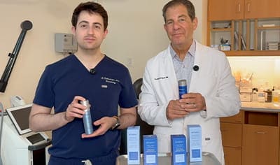 Drs. Joel and Daniel Schlessinger stand next to one another while holding echelon products.