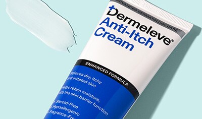 A blue and white bottle of Dermeleve Anti-Itch Cream lays next to a swatch of white cream.