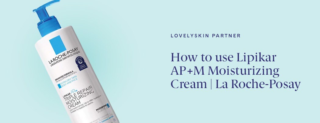 White bottle of La Roche-Posay Lipikar AP+M Triple Repair Body & Face Moisturizer For Dry Skin with a blue pump on a blue background.