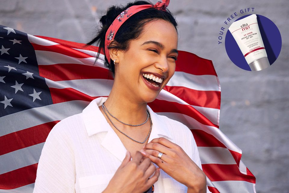 Smiling woman in front of an American Flag