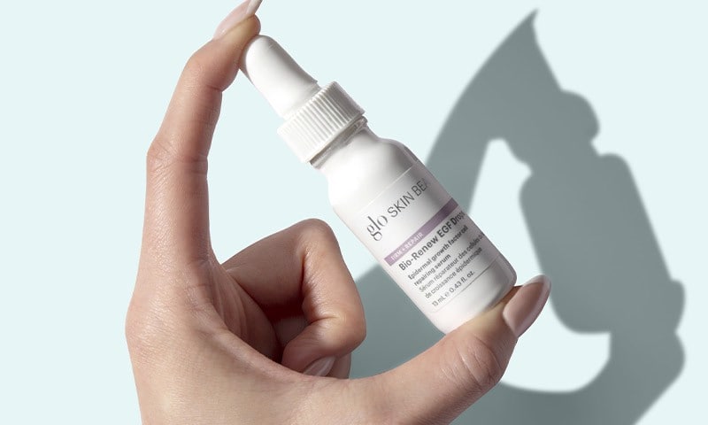 Hand holding serum bottle