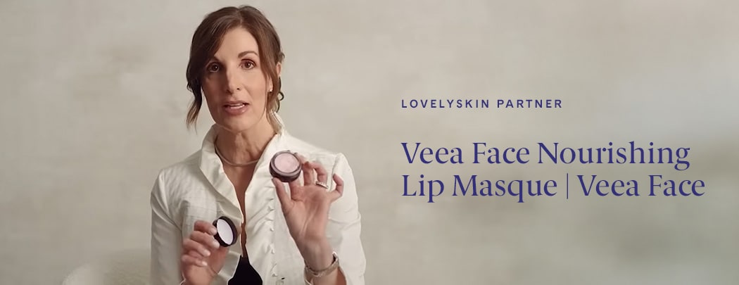 Dr. Suzan Obagi holds the Veea Face Nourishing Lip Masque as she sits in a white chair.