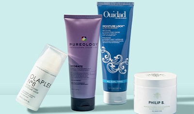Hair masks by OLAPLEX, Pureology, Ouidad and Philip B. pictured on a light blue background.