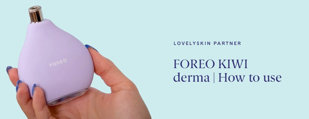 Womans hand holding the FOREO Kiwi derma device