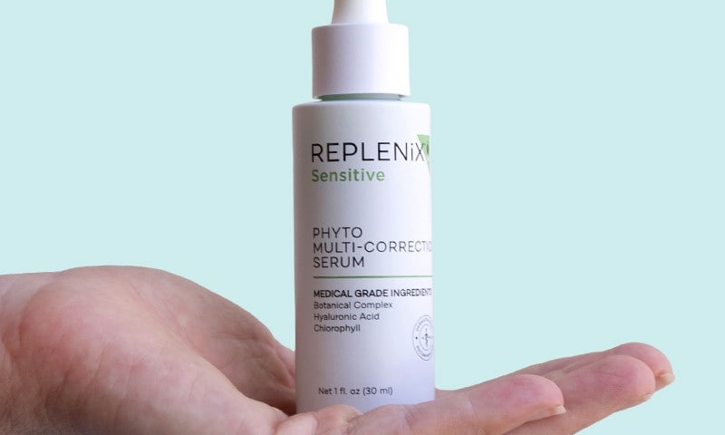 Replenix Phyto Multi-Correction Serum held in palm of hand