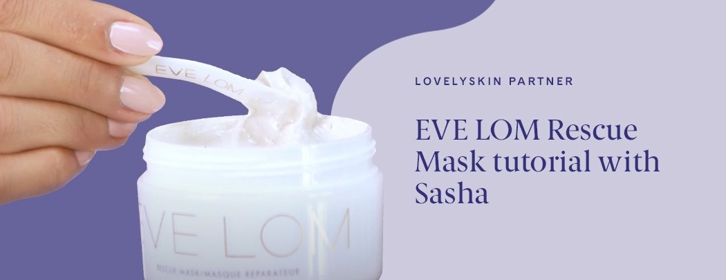 A hand with a medium skin tone and pink nails scoops product out of a jar with an EVE LOM spatula.