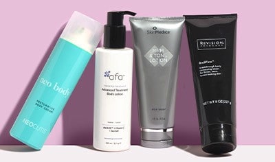 Anti-aging body lotions from Neocutis, afa, SkinMedica and Revision on a pale pink background.